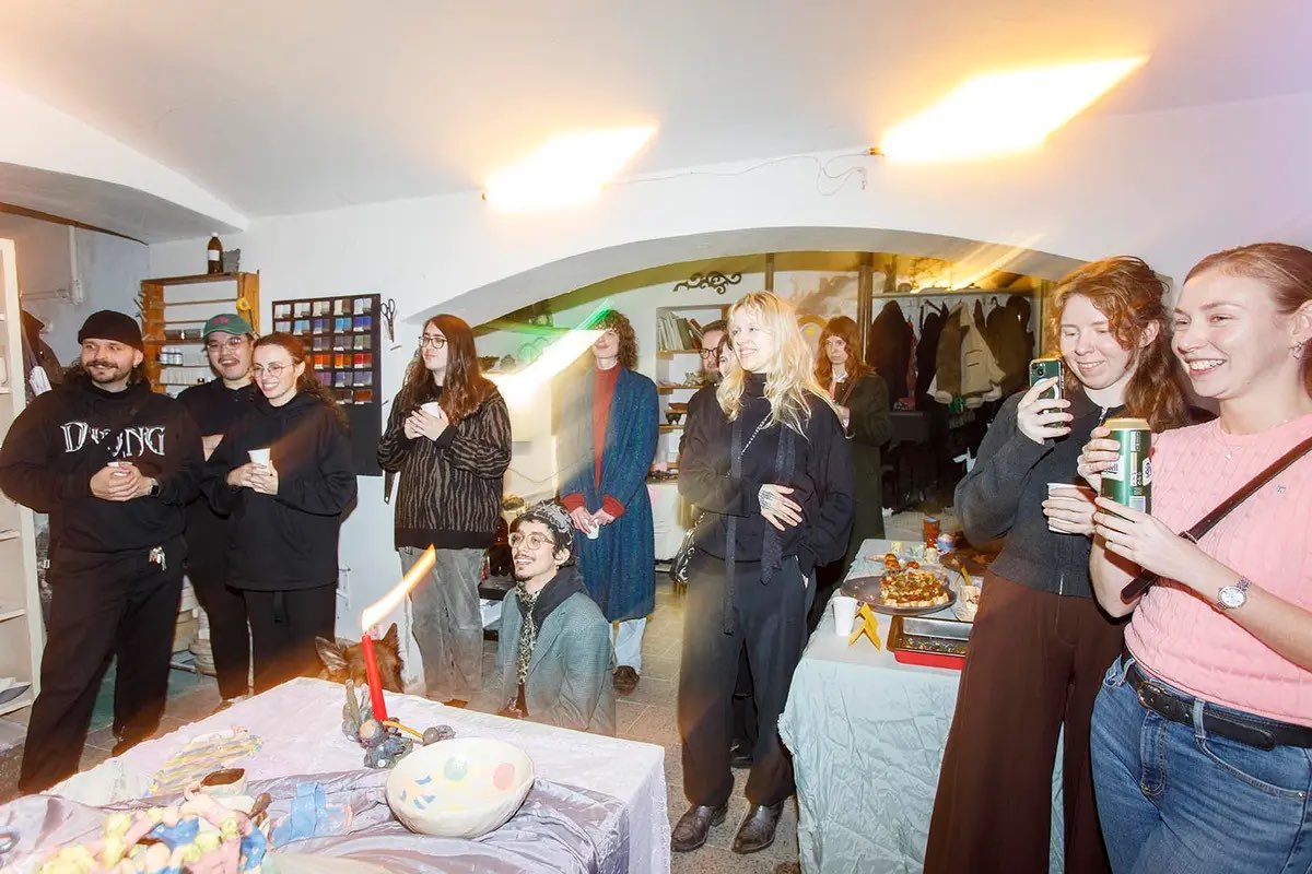 Guests talking and laughing at an evening event in the studio