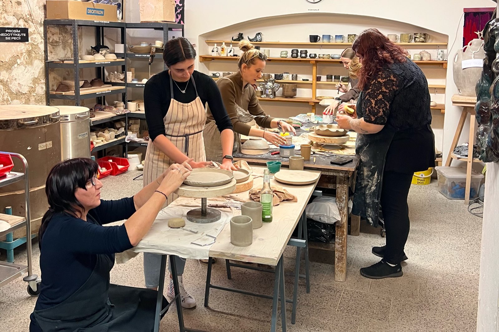 A group working together around a long table in the studio